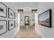 Elegant hallway with framed artwork leading to the fitness studio and Flora spa at 17362 W Wildwood St, Surprise, AZ 85388
