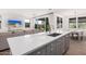 Open-concept kitchen with quartz counters flows into the living and dining areas, perfect for entertaining at 17362 W Wildwood St, Surprise, AZ 85388