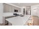 Bright, spacious kitchen features a large quartz island, stainless appliances, and sleek gray cabinetry at 17362 W Wildwood St, Surprise, AZ 85388