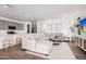 Open-concept living room featuring modern decor, a comfortable sectional, and seamless flow to the kitchen at 17362 W Wildwood St, Surprise, AZ 85388