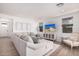 Spacious living room with stylish furnishings, a large sectional, and a view of the entryway and kitchen at 17362 W Wildwood St, Surprise, AZ 85388