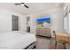 Relaxing main bedroom with mounted television, wood-look floors, and an en-suite bathroom at 17362 W Wildwood St, Surprise, AZ 85388