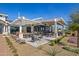 Covered outdoor dining area with modern tables and seating, surrounded by landscaping at 17362 W Wildwood St, Surprise, AZ 85388