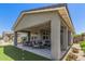Covered patio showing furniture and a putting green in the backyard at 17362 W Wildwood St, Surprise, AZ 85388
