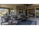 A covered patio space with comfortable seating, a ceiling fan, and access to a grill at 17362 W Wildwood St, Surprise, AZ 85388
