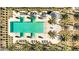 A high-angle aerial shot reveals a geometrically stunning pool area adorned with palm trees and lounge seating at 17362 W Wildwood St, Surprise, AZ 85388