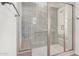Modern shower with decorative tile, glass doors, and a built-in bench for added comfort at 17362 W Wildwood St, Surprise, AZ 85388