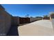 Fenced backyard with gate, concrete area, and lush plants offering privacy and security at 17415 N 57Th Ave, Glendale, AZ 85308