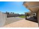 Secluded backyard patio with brick paving, covered area, desert landscaping and a lush green lawn at 17415 N 57Th Ave, Glendale, AZ 85308