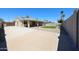 Well-maintained backyard featuring a covered patio, manicured lawn, and desert landscaping for outdoor enjoyment at 17415 N 57Th Ave, Glendale, AZ 85308