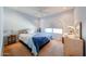 Bedroom showcasing light blue walls, a white ceiling fan, a bed with blue bedding, and an arched window niche at 17415 N 57Th Ave, Glendale, AZ 85308