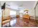 A spacious bedroom with hardwood floors, a ceiling fan, a large window, and furniture at 17415 N 57Th Ave, Glendale, AZ 85308