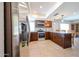 Modern kitchen with stainless steel appliances, granite countertops, and dark wood cabinetry at 17415 N 57Th Ave, Glendale, AZ 85308