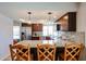 Stylish kitchen featuring granite counters, stainless steel appliances, and a convenient breakfast bar at 17415 N 57Th Ave, Glendale, AZ 85308