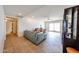 Open-concept living room featuring tile floors, plush seating, and a sliding glass door at 17415 N 57Th Ave, Glendale, AZ 85308
