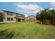 A generous backyard, showcasing a well-kept lawn with exterior views of the house at 17681 W Molly Ln, Surprise, AZ 85387