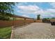 Backyard with gravel area, garden beds, and privacy fence, ready for your personal touch at 17681 W Molly Ln, Surprise, AZ 85387