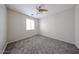 Inviting bedroom with neutral paint, carpet and a modern ceiling fan at 17681 W Molly Ln, Surprise, AZ 85387