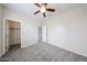 Neutral bedroom featuring carpet, neutral walls and access to closet and door leading out of the room at 17681 W Molly Ln, Surprise, AZ 85387