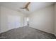 Bedroom features carpet, closet doors, a door leading outside and neutral paint throughout at 17681 W Molly Ln, Surprise, AZ 85387