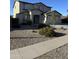 Two-story home featuring a neutral color scheme, a two-car garage, and low maintenance desert landscaping at 17681 W Molly Ln, Surprise, AZ 85387