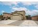 Inviting two-story home showcasing a neutral color scheme, a two-car garage, and low maintenance desert landscaping at 17681 W Molly Ln, Surprise, AZ 85387