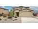 Charming two-story home featuring a well-manicured front yard and attached two-car garage at 17681 W Molly Ln, Surprise, AZ 85387
