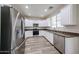 Modern kitchen with stainless steel appliances, granite counters, and white cabinetry at 17681 W Molly Ln, Surprise, AZ 85387