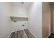 Laundry room featuring wood-look floors, a shelf, and washer/dryer hookups at 17681 W Molly Ln, Surprise, AZ 85387