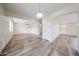 Open-concept living area featuring wood-look floors, neutral walls, and ample natural light at 17681 W Molly Ln, Surprise, AZ 85387