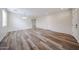 Bright and open living area with modern wood-look flooring and neutral paint at 17681 W Molly Ln, Surprise, AZ 85387
