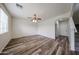 Well-lit living room with wood-look flooring and neutral walls at 17681 W Molly Ln, Surprise, AZ 85387