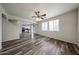 Open living room and kitchen area with wood-look floors and bright natural light at 17681 W Molly Ln, Surprise, AZ 85387
