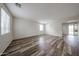 Spacious living room featuring wood-look flooring and lots of natural light at 17681 W Molly Ln, Surprise, AZ 85387