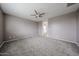 Spacious main bedroom with neutral carpet, light walls, and an ensuite bathroom at 17681 W Molly Ln, Surprise, AZ 85387