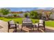 Beautiful backyard area featuring an outdoor seating area, waterfall, and lush lawn at 18226 W Marshall Ct, Litchfield Park, AZ 85340