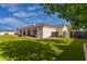 Expansive backyard featuring lush artificial grass, covered patio, and well-maintained landscaping at 18226 W Marshall Ct, Litchfield Park, AZ 85340
