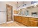 Bathroom with double sinks, granite countertop, walk-in shower, and stone accents at 18226 W Marshall Ct, Litchfield Park, AZ 85340