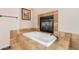 Bathroom with a soaking tub and a fireplace at 18226 W Marshall Ct, Litchfield Park, AZ 85340
