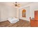 An airy bedroom with a ceiling fan, wood floors, and a shuttered window at 18226 W Marshall Ct, Litchfield Park, AZ 85340