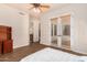 An airy bedroom with wood floors and doors leading to a patio at 18226 W Marshall Ct, Litchfield Park, AZ 85340