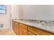 Laundry room featuring ample counter space and wood cabinets, perfect for organizing chores at 18226 W Marshall Ct, Litchfield Park, AZ 85340