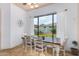 A dining room featuring a wood table, six chairs, and a large window with backyard views at 18226 W Marshall Ct, Litchfield Park, AZ 85340