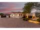 Three car garage, desert landscaping, and soft lighting around this property at 18226 W Marshall Ct, Litchfield Park, AZ 85340