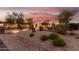 Beautiful home featuring desert landscaping and soft lighting accenting its unique exterior details at 18226 W Marshall Ct, Litchfield Park, AZ 85340