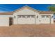 Spacious three-car garage with traditional doors and beautiful exterior lighting at 18226 W Marshall Ct, Litchfield Park, AZ 85340