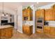 Kitchen boasts stainless steel appliances, custom cabinetry, and open design into living spaces at 18226 W Marshall Ct, Litchfield Park, AZ 85340