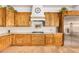 Gourmet kitchen features custom wood cabinets, granite countertops, and stainless steel appliances at 18226 W Marshall Ct, Litchfield Park, AZ 85340