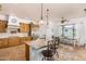 Bright kitchen featuring travertine floors, granite counters, and a breakfast nook at 18226 W Marshall Ct, Litchfield Park, AZ 85340