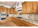 Kitchen with custom wood cabinetry, granite countertops, gas cooktop and stainless steel appliances at 18226 W Marshall Ct, Litchfield Park, AZ 85340